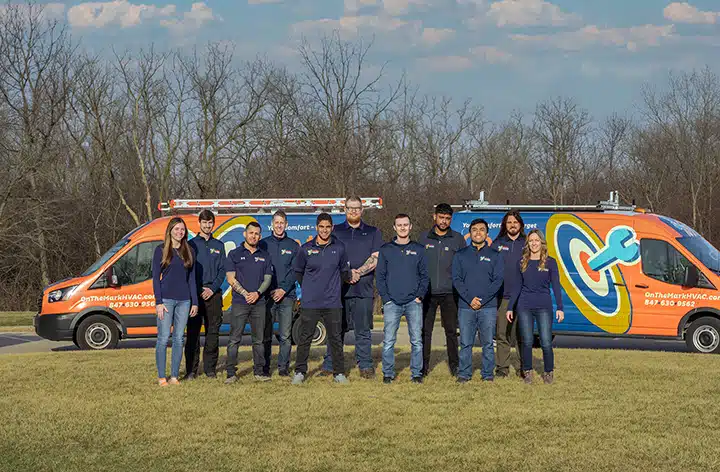 On the Mark team photo with fleet vans in Arlington heights