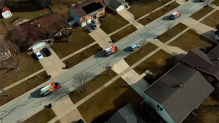 On the Mark vans driving on streets in Arlington Heights